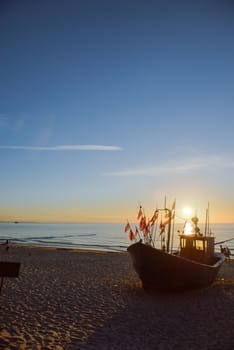fisherman boats at sunrise time on the beach in summer