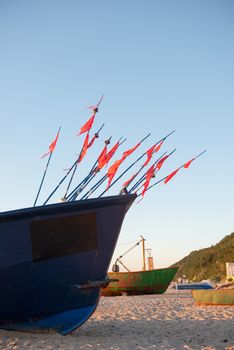 fisherman boats at sunrise time on the beach in summer