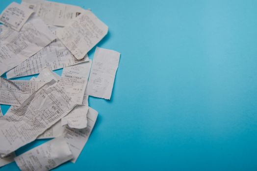 Pile of shopping receipts on a blue background