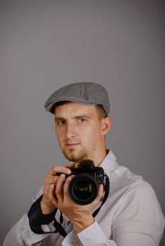 Young man using a professional camera in studio