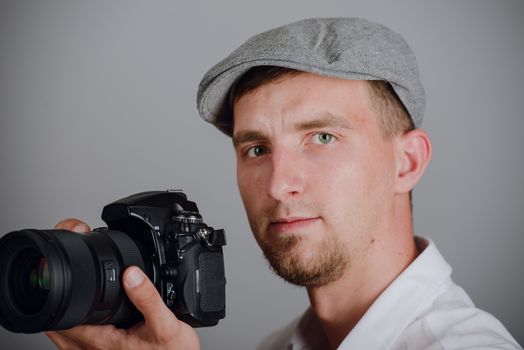 Young man using a professional camera in studio