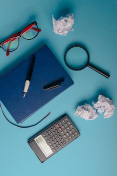 Desk with Tools and Notebook office desk on blue background