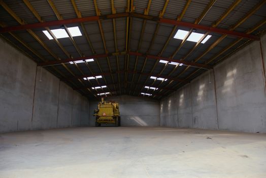 combine harvester standing ready for harvest in a warehouse