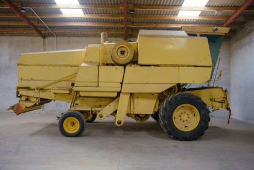 combine harvester standing ready for harvest in a warehouse