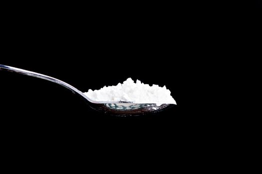 Isolated spoon of white powder. Can be flour, wheat, of some sort of drug.