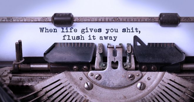 When life gives you shit, flush it away, written on an old typewriter, vintage