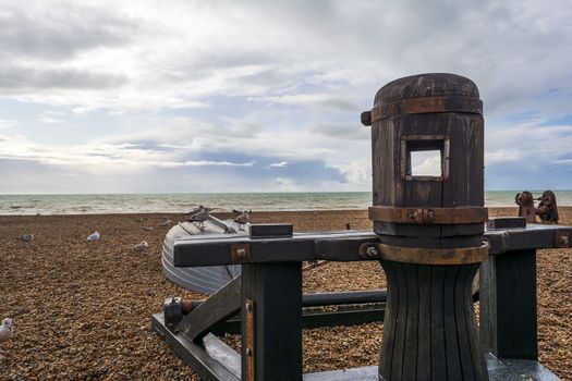 Seagulls standing on a small wrecked boat in Brighton's beach in autumn.