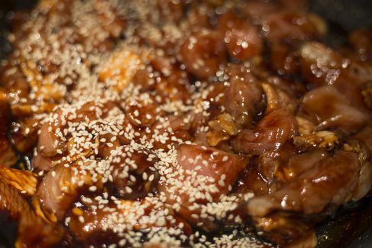 Teriyaki chicken and sesame cooking background close up