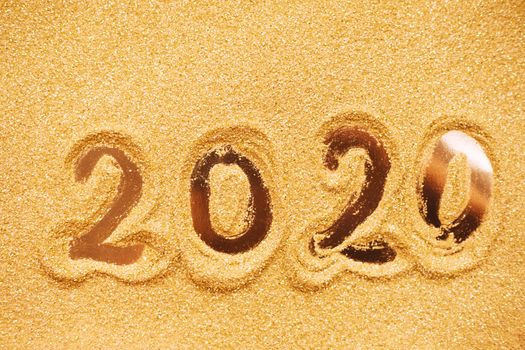 Hand drawn2020 Happy new year symbol on golden glitter background