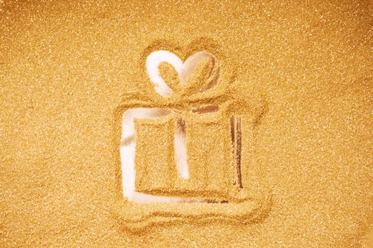 Hand drawn Christmas gift box symbol on golden glitter background