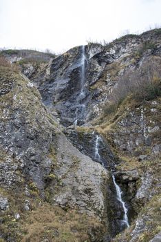 Polikarya waterfall in the Caucasus mountains near Sochi, Russia. Cloudy day 26 October 2019.