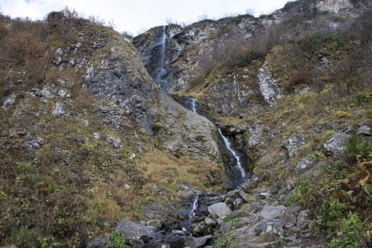 Polikarya waterfall in the Caucasus mountains near Sochi, Russia. Cloudy day 26 October 2019.