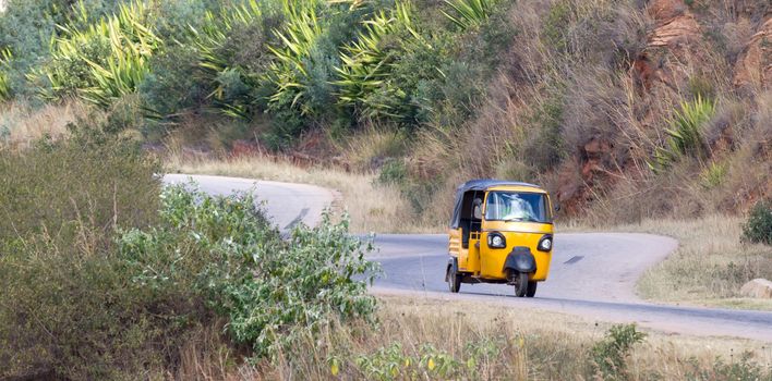 Tuktuk taxi on Madagascar, moving through the mountains