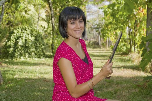 casual woman working with a tablet pc, outdoor