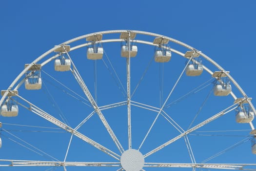 fun for children.Big ferris wheel with the blue sky in the background