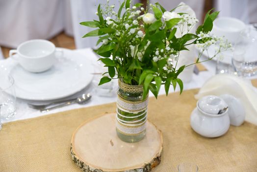 Wedding table set for fine dining or other catered event, center-piece