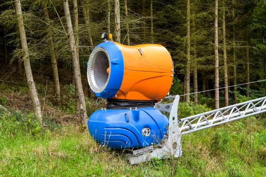 Snow blowing machines or snow cannons making snow
