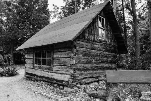 Abandoned old wooden house Cabin in the woods.  View of old weathered wooden
