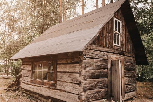 Abandoned old wooden house Cabin in the woods.  View of old weathered wooden