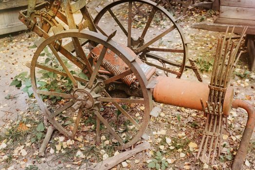 abandoned rusty old farm machinery in garden