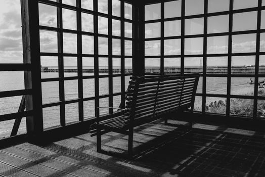 Can take relax on the wooden bench with view of sea in black and white concept