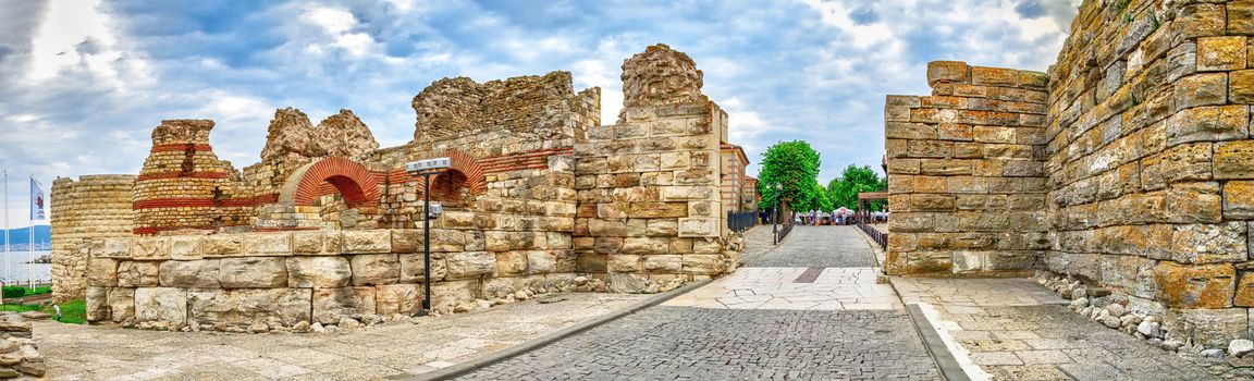 Nessebar, Bulgaria – 07.10.2019.  Ruins of ancient fortifications at the entrance to the Old Town of Nessebar, Bulgaria, on a cloudy summer morning