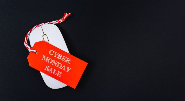 Online shopping Cyber Monday sale text red tag on white mouse with black background