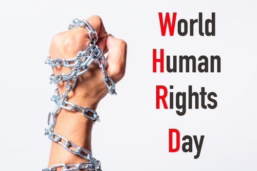 Chained fist hands with WORLD HUMAN RIGHTS DAY text on white background, Human rights day concept