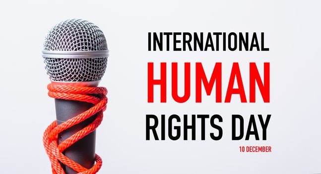 Rope on microphone with INTERNATIONAL HUMAN RIGHTS DAY 10 DECEMBER text on white background, Human rights day concept