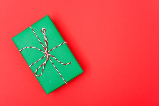New Year, Christmas Xmas holiday composition, Top view green gift box on red background with copy space