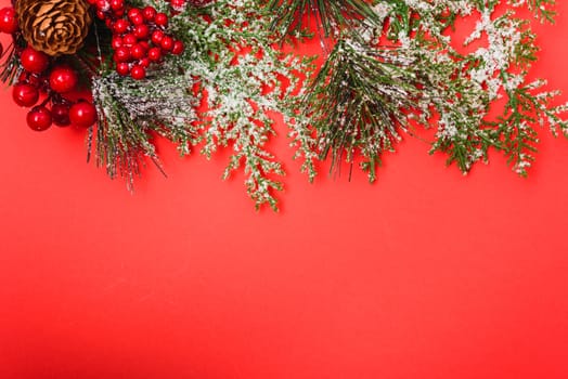 Christmas decorations, fir tree branches on red background. Merry Christmas concept. With Copy space for text