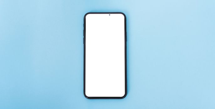 Top view of modern technology smart phone mobile on blue background with copy space