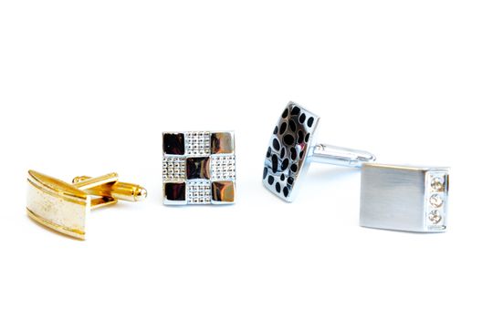 Group of modern stainless steel cufflinks isolated on white background. Lifestyle trendy clothing accessories dress with clipping path and copy space.