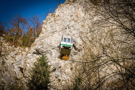 Cableway with blue sky and rocks background. Cable cabin in Moravia.