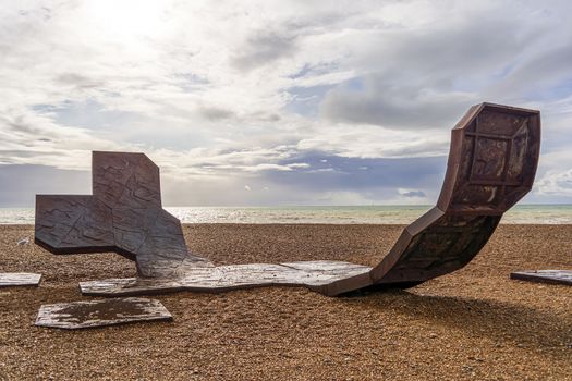 Brighton and Hove, East Sussex, UK - November 4, 2019: Passacaglia sculpture by Charles Hadcock on the beach in Brighton, UK. Passacaglia is a huge, curved abstract sculpture by Charles Hadcock. It is constructed from recycled cast iron, weighs 20 tonnes and is five meters high.