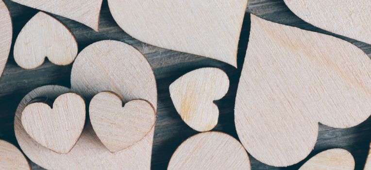 Many wooden colorless hearts background