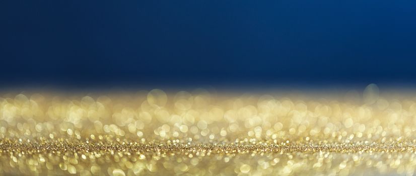 Golden and blue christmas background with bokeh lights