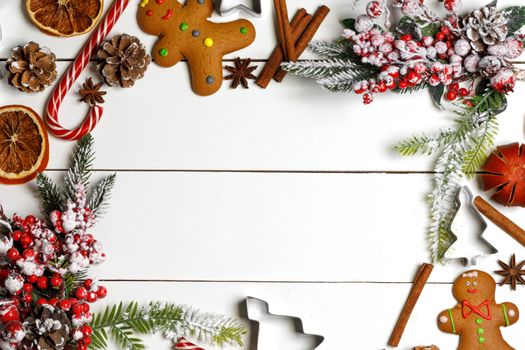 Christmas flat lay background with traditional gingerbread cookies dried orange cinnamon on wood , copy space for text