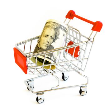 Twenty-dollar bill (20) banknote and small shopping cart isolated on white background. Denominations US with tiny silver, red metallic push cart, online shopping concept
