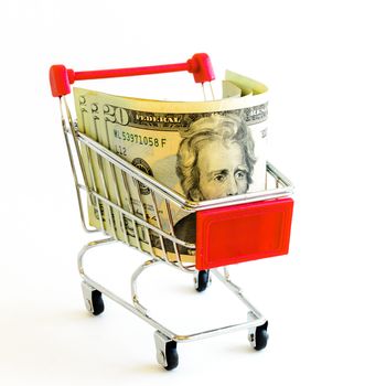 Twenty-dollar bill (20) banknote and small shopping cart isolated on white background. Denominations US with tiny silver, red metallic push cart, online shopping concept
