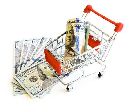 Stack of one hundred (100) dollars banknote and small shopping cart isolated on white background. Large denominations US bill with tiny silver, red metallic empty push cart, online shopping concept