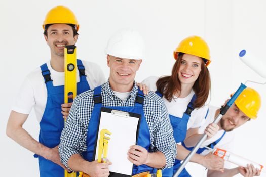 Group of professional industrial workers with tools and contract