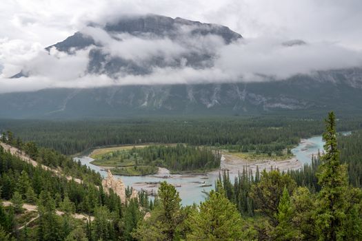 Panoramic image of the Hoodoos close to Banff with the Bow river and the Mount Rundle under clowds in the background, Banff National Park, Alberta, Canada