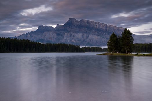 Panoramic image of Mount Rundle reflecting in Two Jack Lake with early morning mood, Banff National Park, Alberta, Canada