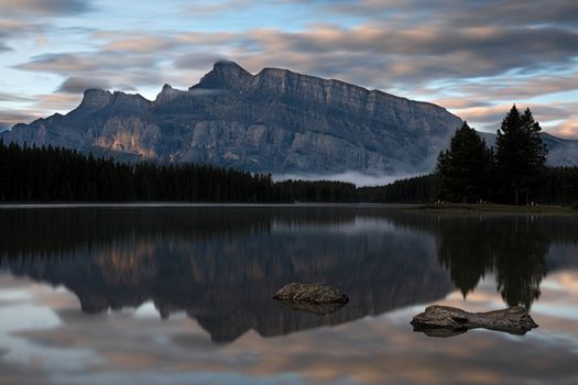 Panoramic image of Mount Rundle reflecting in Two Jack Lake with early morning mood, Banff National Park, Alberta, Canada