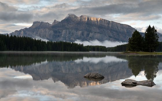 Panoramic image of Mount Rundle reflecting in Two Jack Lake with early morning mood, Banff National Park, Alberta, Canada