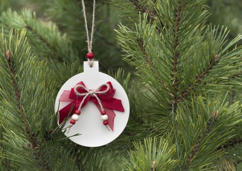 Homemade wooden Christmas decorations for the Christmas tree. Traditional christmas hand made decoration hanging on fir tree.