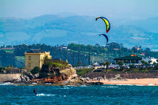 Kitesurfers next to the the Camel beach of Santander, Cantabria, Spain. The rocks are like the hump of a Camel.