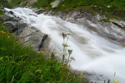 Waterfall in Italy Alps mountain landscape