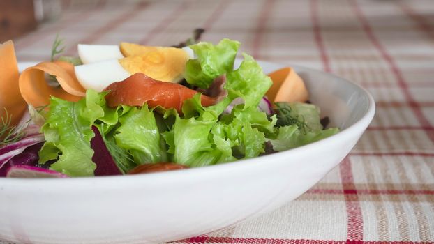 Fresh salmon vegetable healthy salad on white plate ready for eating - fresh clean healthy food recipe for background use